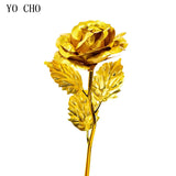 All yellow gold plated rose with gold stem and leaves on white background