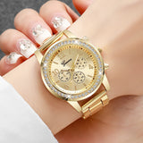 Gold rhinestone watch with sunray dial worn on a wrist