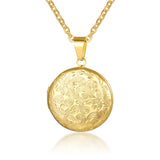Gold round photo locket with engraved floral design on a fine gold chain