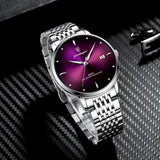Silver watch with green sunray dial and steel bracelet shown at an angle