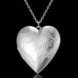Silver heart photo locket with all-over etched pattern on a chain against black