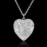 Silver heart locket with detailed floral engraving on a fine silver chain