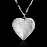 Silver heart photo locket with scrolled leaf engraving on a chain
