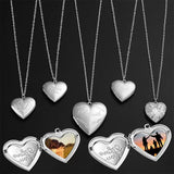 Row of silver heart photo lockets in varied engraved patterns on fine chains