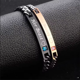 Close view of rose gold engraved bar with crystal accent on a steel chain bracelet