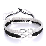 Black and white braided rope bracelets joined by a silver infinity charm