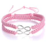 Pink braided rope bracelet with a silver infinity charm