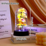 White foil rose glowing under a glass dome on a dark base against black