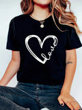 Close-up of black t-shirt with black heart and wing graphic worn on torso