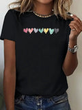 Black t-shirt with colorful love text and heart graphic worn by a woman