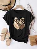 Black t-shirt with double leopard print heart graphic shown on a hanger