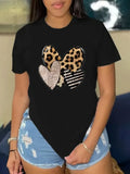Close-up of black t-shirt with leopard print heart graphic worn on torso