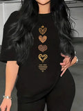 Close-up of black t-shirt with a row of small gold heart graphics