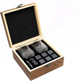 Light wood gift box open at an angle holding two tumblers and grey granite chilling stones