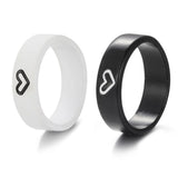 Black and white heart engraved rings displayed flat side by side