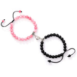 Pink and black matte stone bead bracelet pair with magnetic heart clasp detail