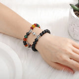 Two magnetic stone bead bracelets worn side by side showing matching heart clasps