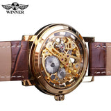 Gold case skeleton watch with brown leather strap shown front facing on white background