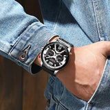 Man wearing the rose gold leather chronograph watch with hand by his jeans pocket