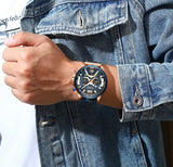 Man in a denim jacket wearing the rose gold leather chronograph watch on his wrist