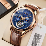 Rose gold automatic moon phase watch with blue dial and brown leather strap