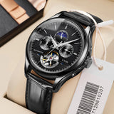 Silver automatic watch with skeleton dial and dark leather strap