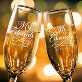 Custom engraved Mr and Mrs champagne flutes clinking together in a toast