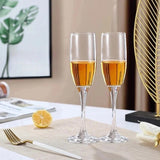 Custom engraved champagne flutes displayed on a wedding table shown at a different angle