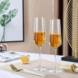 Custom engraved champagne flutes on a wedding table with place settings and gold accents