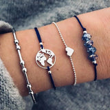 Navy cord and silver chain bracelet stack with small pendant worn on a wrist