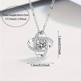 Silver love knot necklace shown with printed message card inside a black gift box