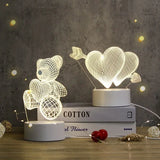 Etched acrylic night lights with teddy bear and heart designs styled with a rose
