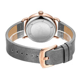 Grey watch strap coiled to show plain steel caseback and tan strap lining