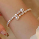 Delicate pearl and gold bead bracelet worn on a wrist