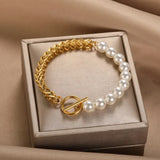 Gold and pearl bracelet with knot detail presented in a white gift box