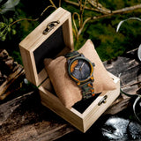 Wooden watch displayed inside an open wooden gift box shown from the front