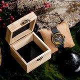 Wooden watch displayed inside an open wooden gift box shown at a side angle