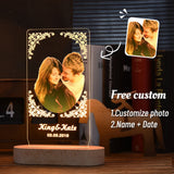 Backlit photo lamp of a couple with etched names and date on a dark background