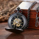 Black mechanical pocket watch open showing skeleton dial and chain