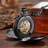 Black mechanical pocket watch open on a stand showing skeleton movement
