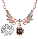 Rose gold angel wings pendant necklace paired with a round projection charm
