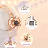 Close-up of rose gold heart projection pendants with light beam effect