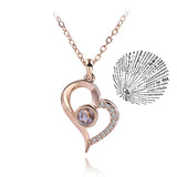 Rose gold heart outline pendant necklace paired with a round projection charm