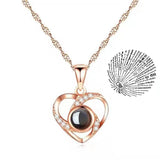 Rose gold heart pendant necklace paired with a round projection charm
