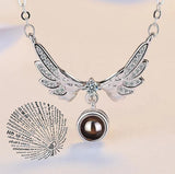 Silver angel wings pendant necklace and matching earrings with projection charm