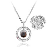 Silver heart pendant necklace paired with a round projection charm