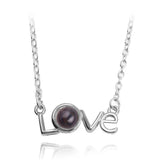 Silver love script pendant necklace with dark projection stone