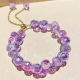 Double strand bracelet with purple and pink faceted crystal beads on gold chain