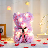Purple and pink rose flower teddy bear with black bow and glowing LED lights
