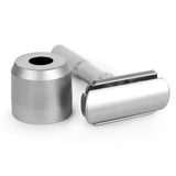 Close-up of double edge razor head beside chrome stand base showing knurled grip